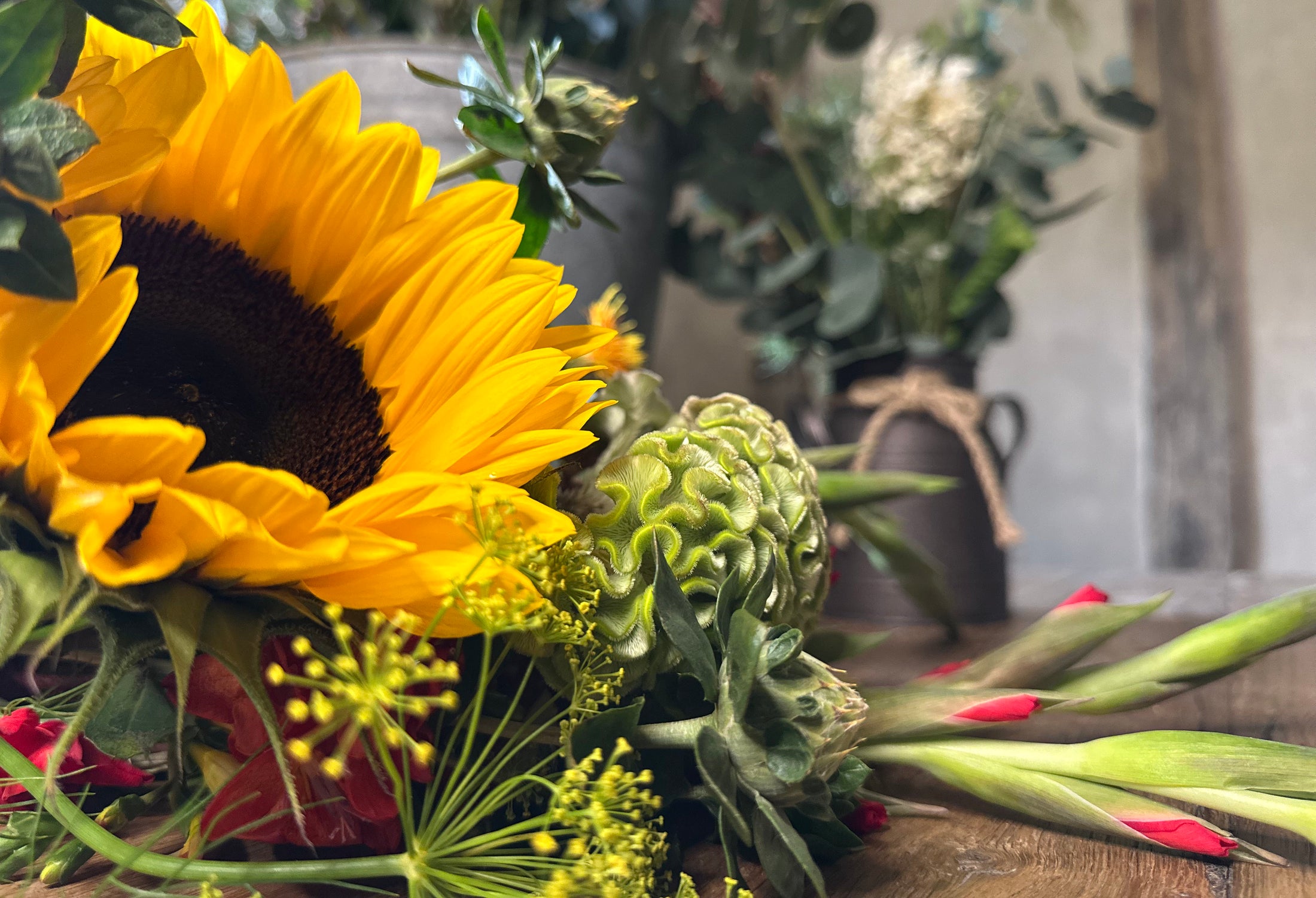 Close-up of a sunflower and other flowers with a blurred background